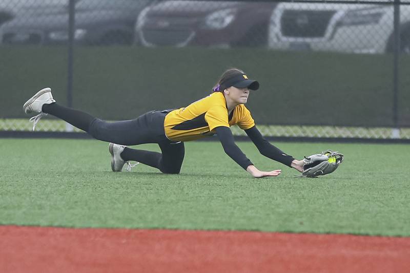 Joliet West's Caitlin Jadron (11) makes a diving catch during softball game between Joliet West at Yorkville on Wednesday, April 30, 2025 in Yorkville.