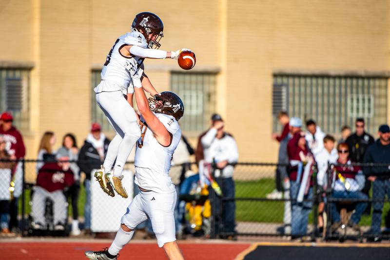 Joliet Catholic's Keegan Farnaus gets a celebration lift from Ryan Yurisich after his touchdown during the 5A Quarterfinals game on Saturday Nov. 11, 2023 at Morris High School.