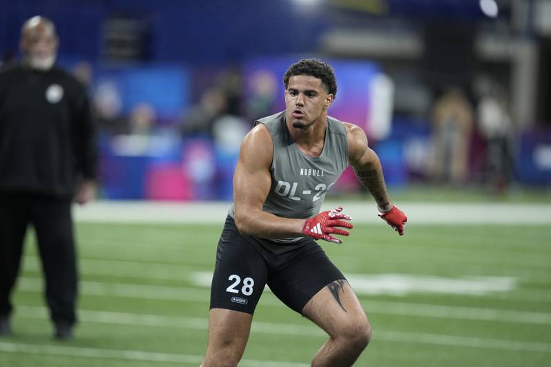 Kansas defensive lineman Austin Booker runs a drill at the NFL football scouting combine, Thursday, Feb. 29, 2024, in Indianapolis.