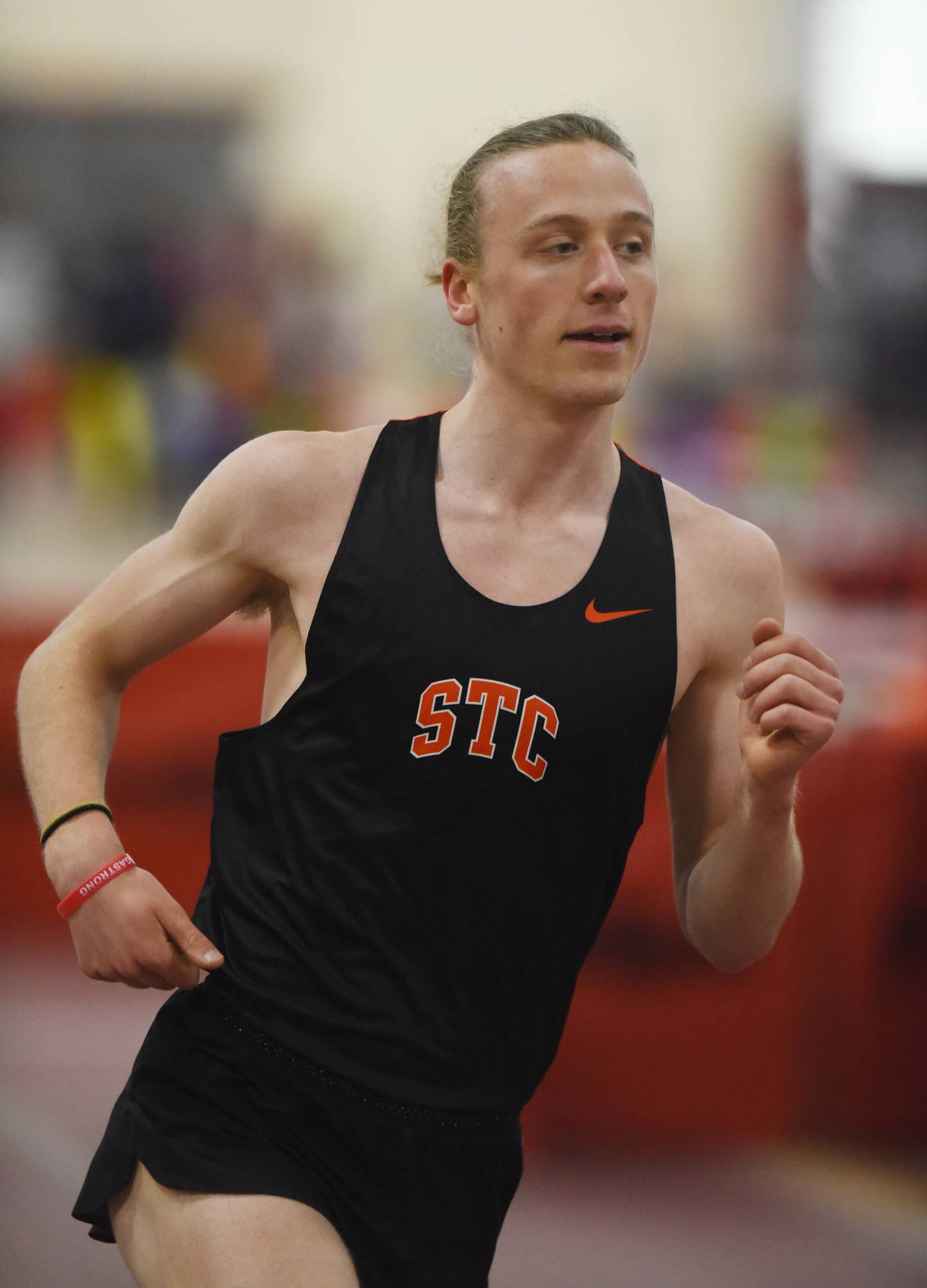 St. Charles East's Micah Wilson competes on his way to a first-place finish in the 3,200-meter run during the DuKane boys indoor track meet at Batavia High School Saturday.