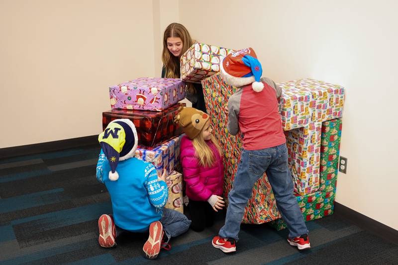 Kids take a break from the cold to play with Christmas present building blocks at the Joliet Public Library at the Joliet Light Up the Lights Holiday Festival on Friday, Nov. 29, 2024.