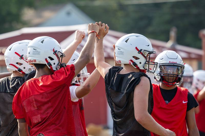 Players of Streator huddle for team break on Monday, August 11, 2025 at Streator High School in Streator.