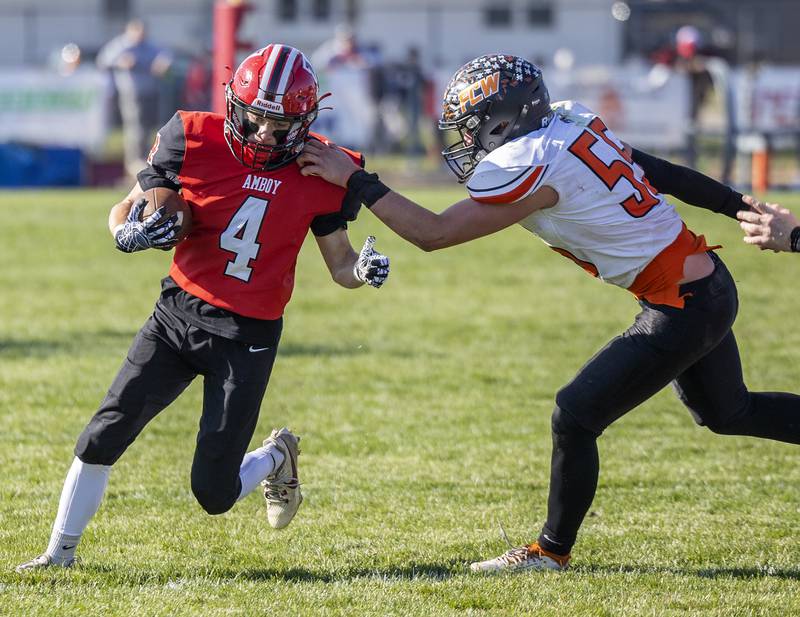 Amboy’s Josh McKendry looks to get away from FCW’s Kesler Collins Saturday, Nov. 4, 2023 in the 8-man semifinal game in Amboy.