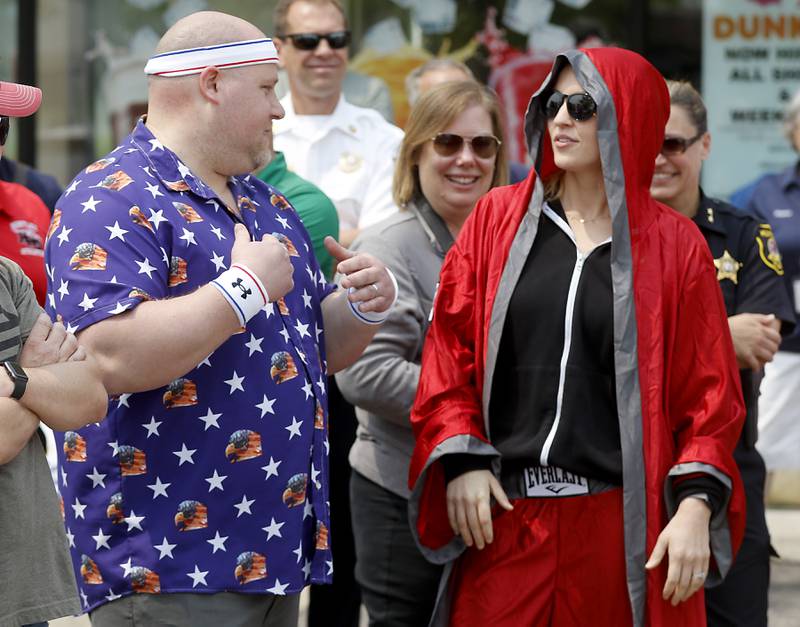 Donut eating contestants Matthew Ganek of the Huntley Police Department and Jill Kowalyszyn of the Huntley Parks Department size each other up before competing at Dunkin’ Donuts, in Huntley, during the Cop on a Rooftop fundraiser to raise awareness for Special Olympics Illinois and the Law Enforcement Torch Run to benefit Special Olympics on Friday, May 19. 2023. Huntley Police Department officers, in support of the Law Enforcement Torch Run for Special Olympics Illinois, took to the roofs and ground around both Huntley Dunkin’ Donuts locations before finishing the day with the seventh annual donut-eating contest. Ganek won the competition.