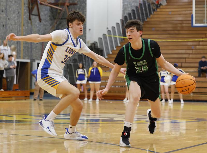 York's Joseph Lubbe (25) tries to get past Lyons' Nate Woods during a varsity basketball game between York Community and Lyons Township high schools on Friday, Jan. 9, 2026 in La Grange.