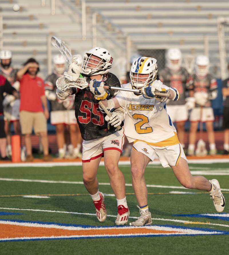 Huntley's Andrew Baumley and Lake Forest's John Blume battle for a loose ball during the boys lacrosse supersectional match on Tuesday, May 31, 2022 at Hoffman Estates High School.