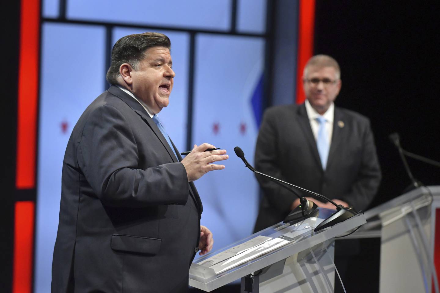 Illinois Gov. JB Pritzker, left, speaks as his Republican challenger state Sen. Darren Bailey, right, listens during the Illinois Governor's Debate on the stage in Braden Auditorium at the campus of Illinois State University in Normal, Ill., Thursday, Oct.6, 2022 (Ron Johnson/Illinois State University via AP, Pool)