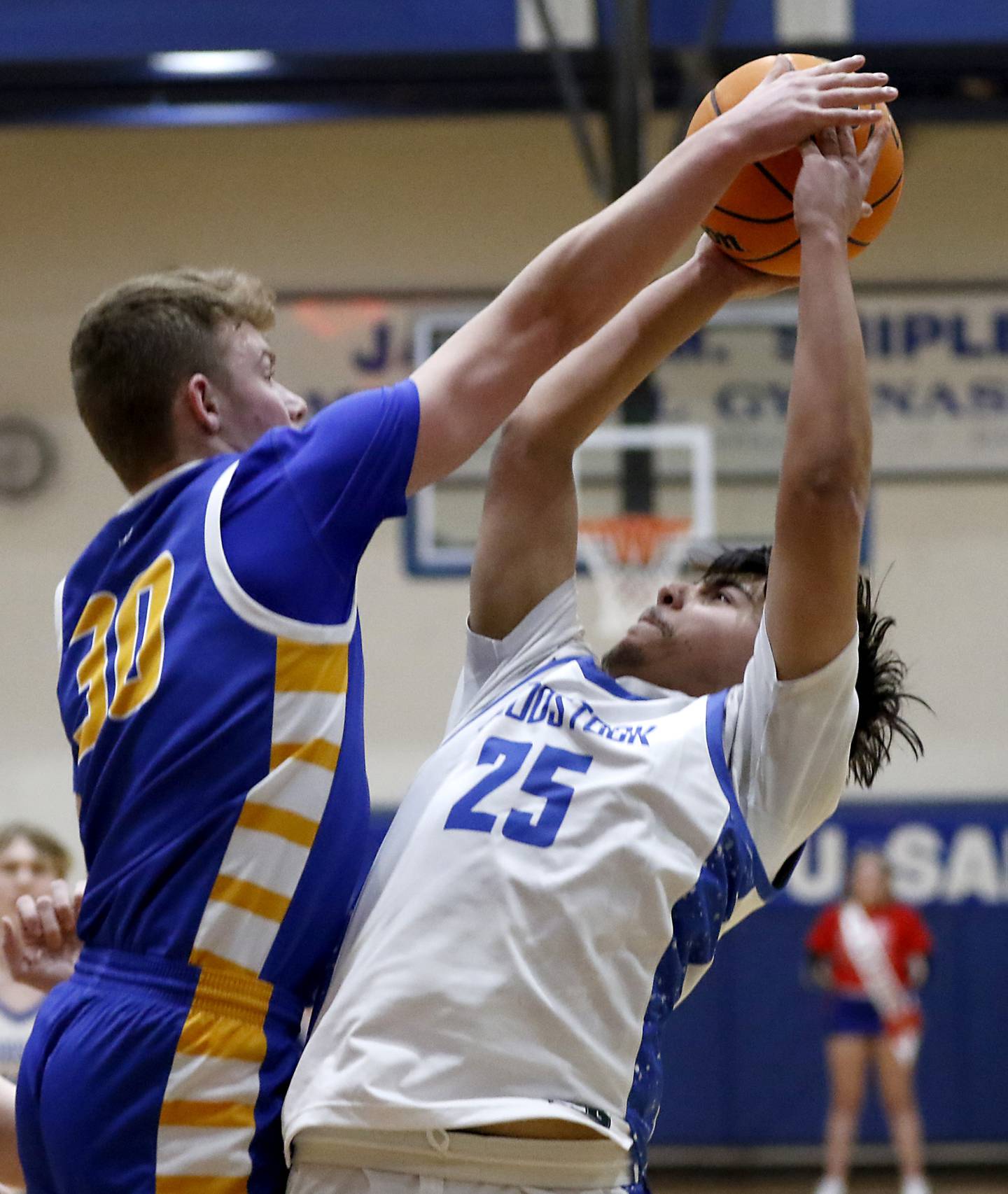 Johnsburg's Jayce Schmitt blocks the shot of Woodstock's Denzel Juarez during a Kishwaukee River Conference basketball game on Friday,  Feb. 14, 2025, at Woodstock High School.