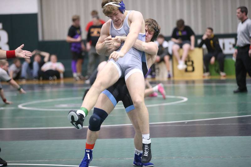 Marquette's Reily Leifheit lifts up Princeton's Casey Etheridge in the 165 weight class during the Class 1A Regional meet on Saturday, Feb. 8, 2025 at St. Bede Academy.