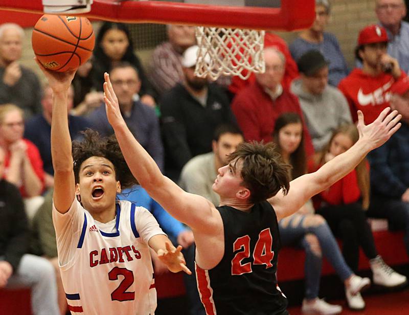 Marmion's Jabe Haith looks to shoot over Metamora's Drew Tucker during the Class 3A Super-Sectional on Monday, March 6, 2023 at Ottawa High School.