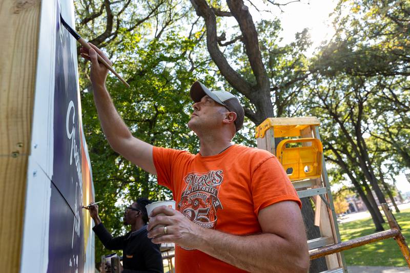 Curt Bedei of the Walldogs paint Streator mural on top of scaffolding on Thursday, Sept. 11, 2025 at City Park in Streator.