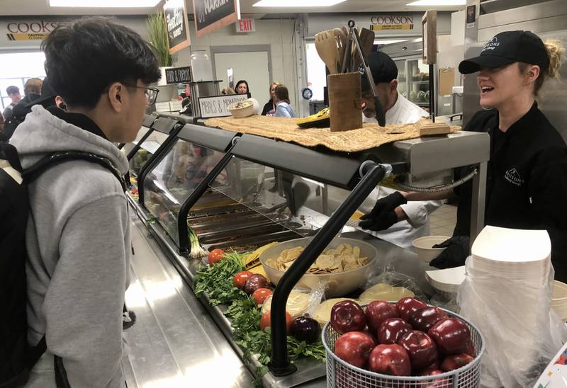 Chefs with Whitsons Culinary Group, the new food service provider of Y115, serve tacos to Yorkville High School students at a Feb. 9, 2024, pop-up event in the high school cafeteria at 797 Game Farm Road.