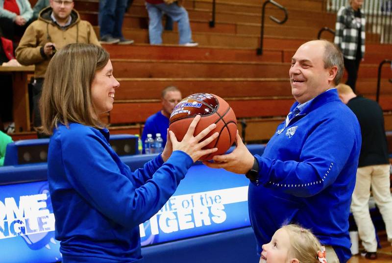 Princeton  coach Tiffany Gonigam receives a commemorative ball from athletic director Jeff Ohlson for becoming the all-time winningest coach in program history Monday night. Ohlson was her coach at Bureau Valley.