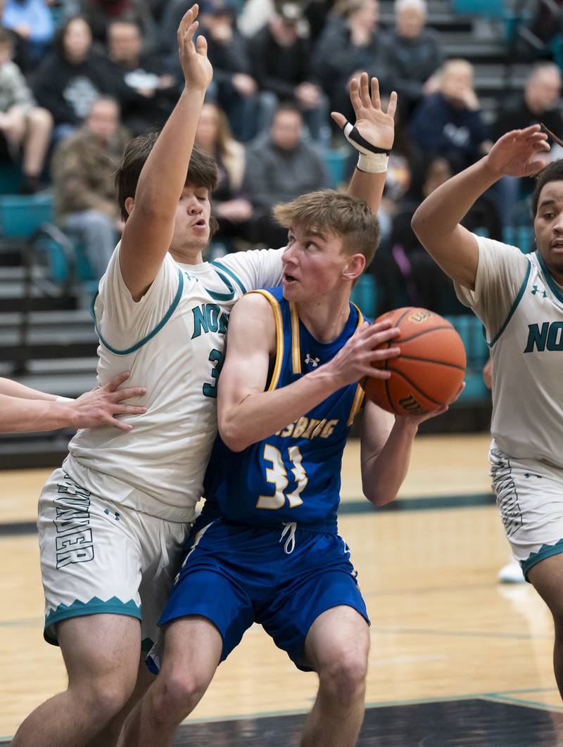 Johnsburg's JT Schmitt is defended by Woodstock North's Carter Brey during their game on Wednesday, January 31, 2024 at Woodstock North High School. Ryan Rayburn for Shaw Local