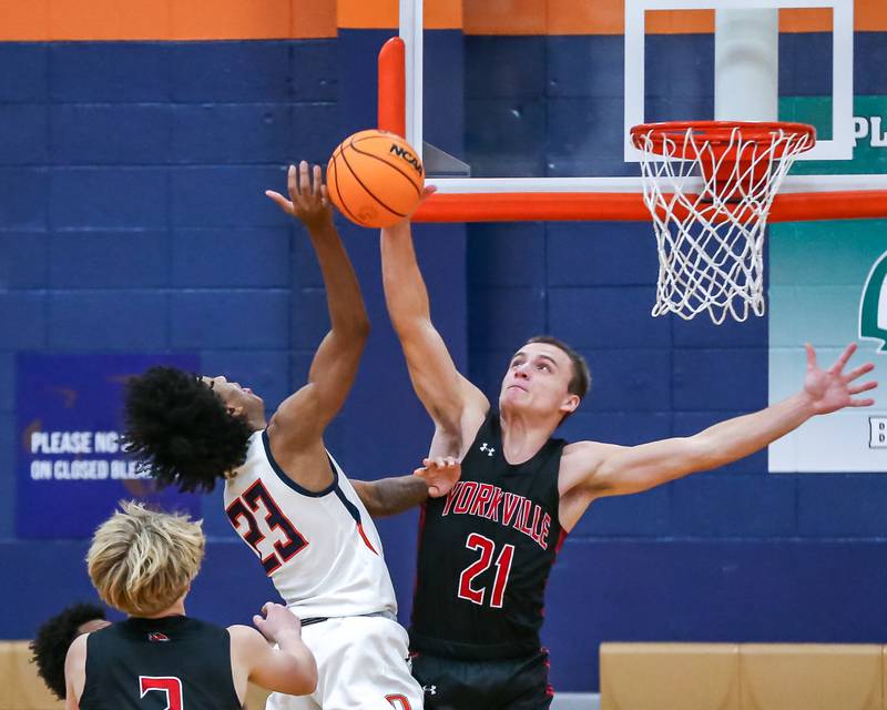 Yorkville's Taelor Clements (21) blocks a shot attempt during their basketball game between Yorkville at Oswego, Tuesday Dec 10, 2024 in Oswego.