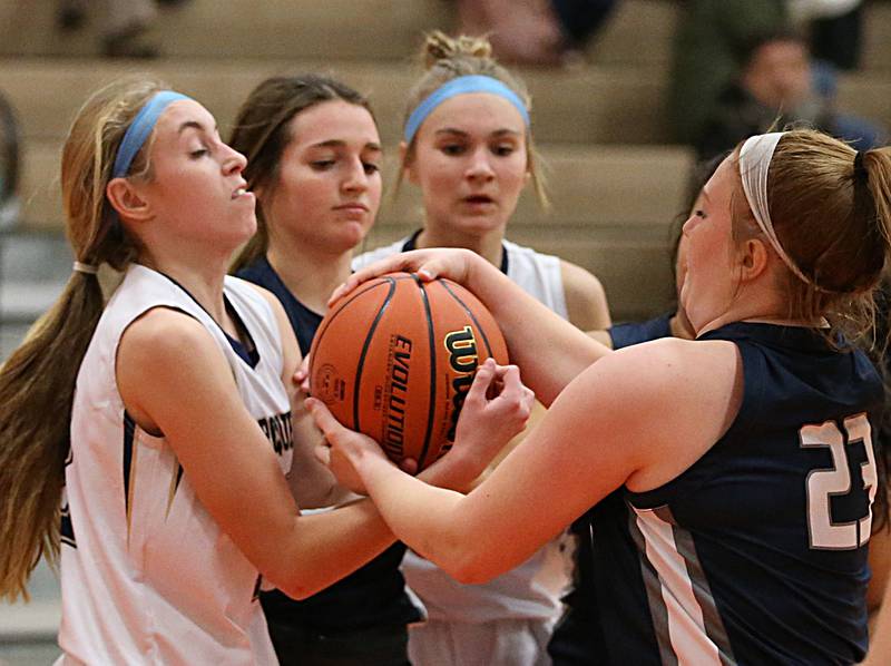 (From left) Marquette's Lilly Craig Fieldcrest's Kaitlin White, Marquette's Avery Durdan and Fieldcrest's Riley Burton fight for a loose ball in the Integrated Seed Lady Falcon Basketball Classic on Thursday, Nov. 17, 2022 in Flanagan.