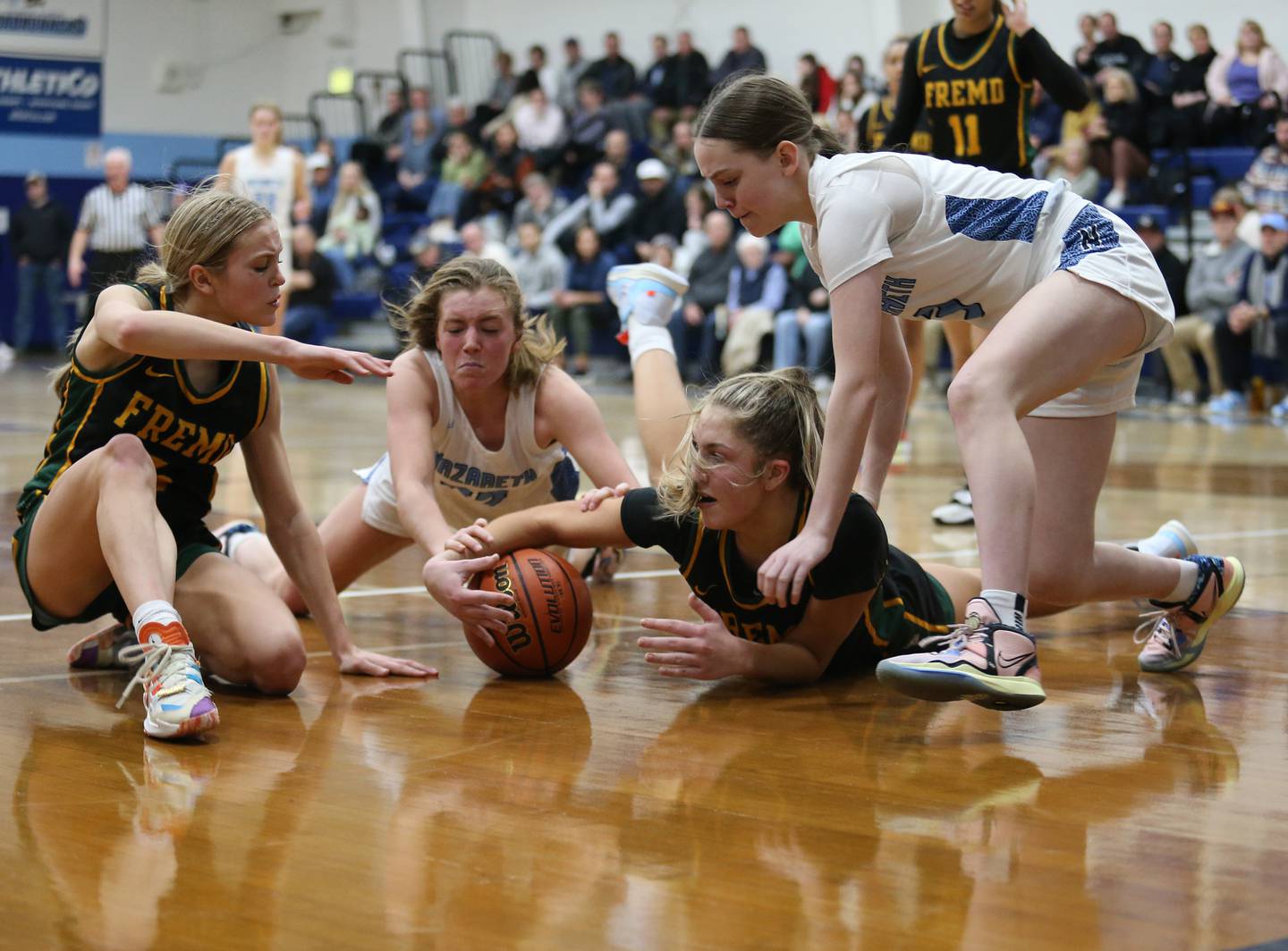 Fremd and Nazareth scramble for a loose ball during the girls varsity basketball game on Monday, Jan. 9, 2023 in La Grange Park, IL.