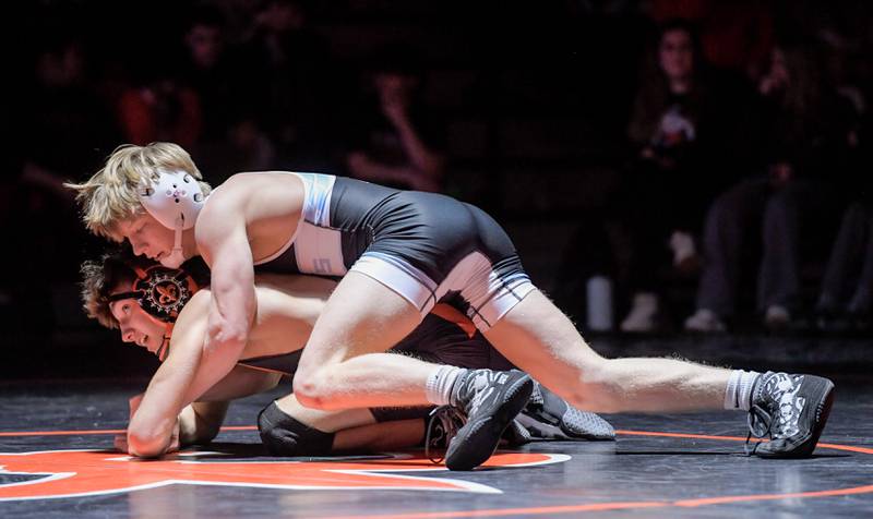 Marian Central's Brayden Tuennisen, top, and St. Charles East's Gavin Woodmancy wrestle at 126 pounds during a match in St. Charles on Wednesday, December 20, 2023.