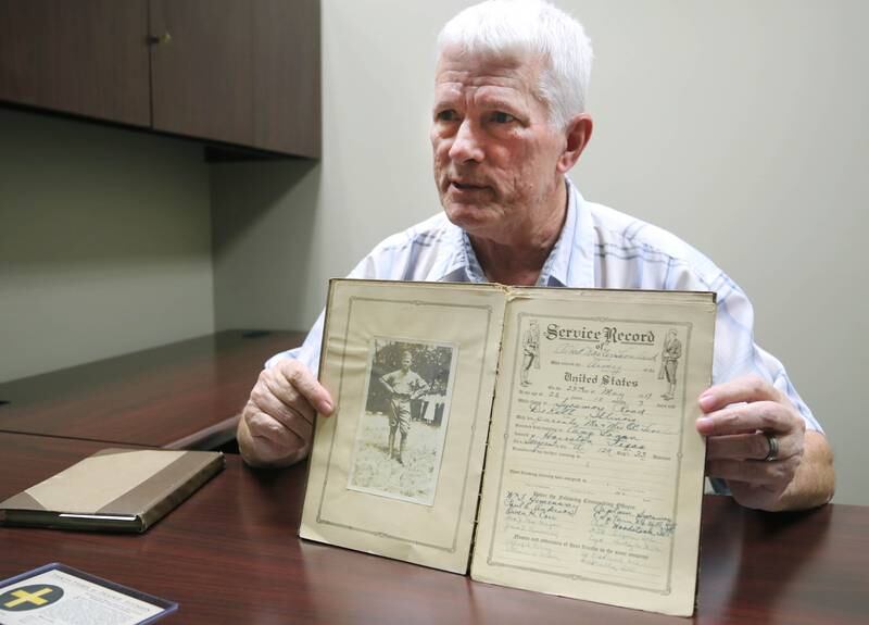 DeKalb resident John Wright talks about a photo of WWI U.S. Army soldier Albert Leonhard Monday, Oct. 7, 2024, that he found in a service record book he purchased at a local estate sale.