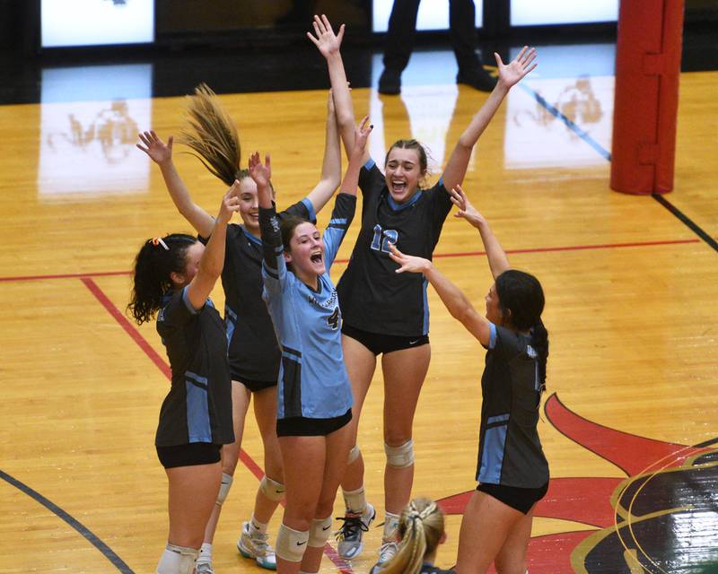 Willowbrook's Grace C Conley (4) and Elle Bruschuk (12) celebrate their victory over York in Monday's Proviso West Class 4A girls sectional volleyball match in Hillside.