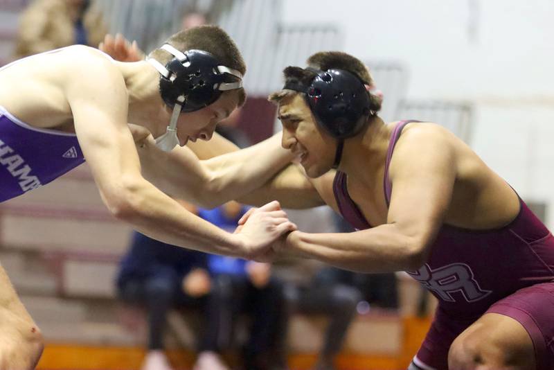 Prairie Ridge’s  Aiden Rodriguez, right, battles Hampshire’s John Janicki at 175 pounds in varsity boys wrestling on Thursday, Dec. 4, 2025, at  Prairie Ridge High School in Crystal Lake.
