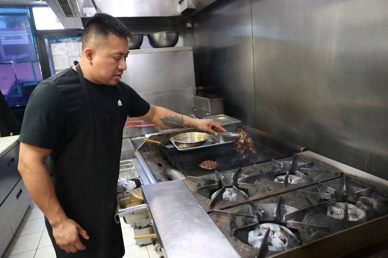 Luis Gachupin works the grill at Urban Kitchen on Wednesday, Nov. 15, 2023, in Joliet.