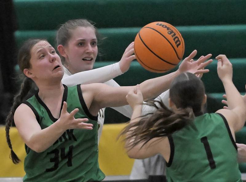 York’s Olivia Silkaitis and Cate Carter, right, fight for a loose ball with Stevenson’s Alexa Karcz in a girls basketball game in Lincolnshire on Thursday, Feb. 6, 2024.