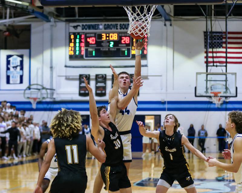 Downers Grove South's Justin Sveiteris (44) puts up a lay up over Hinsdale South's Brendan Savage (30) during basketball game between Hinsdale South at Downers Grove South. Dec 1, 2023.
