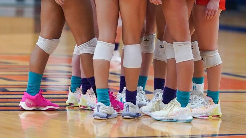 Oswego and Yorkville players each wore one teal sock for suicide awareness during their volleyball match at Oswego High School on Thursday, Sept. 14, 2023.