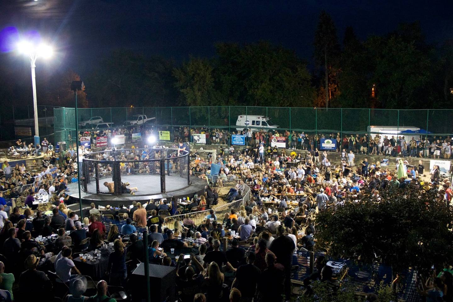 Spectators enjoy the night-time portion of the show at the Outdoor War MMA event at Sideouts in Island Lake in 2014. After a six-year hiatus, the popular XFO event returns to Sideouts Aug. 9.