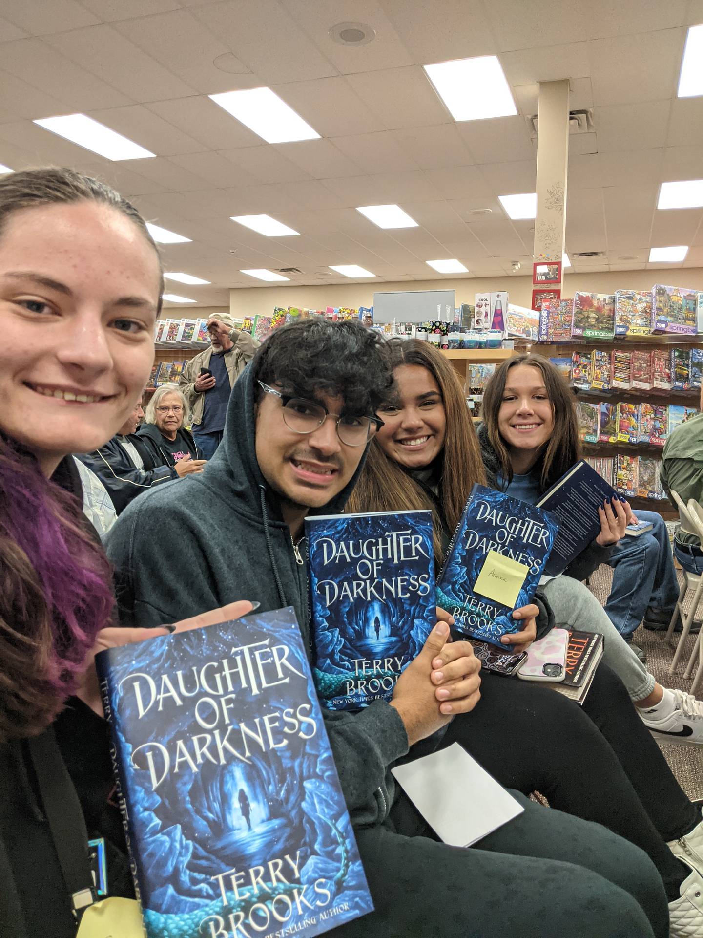 Savanna Wood-Kendrick, Raul Garcia-Fernandez, Ariana Diaz and Makenna Arickz hold up signed copies of "daughter of darkness," the latest novel by Sterling native Terry Brooks.