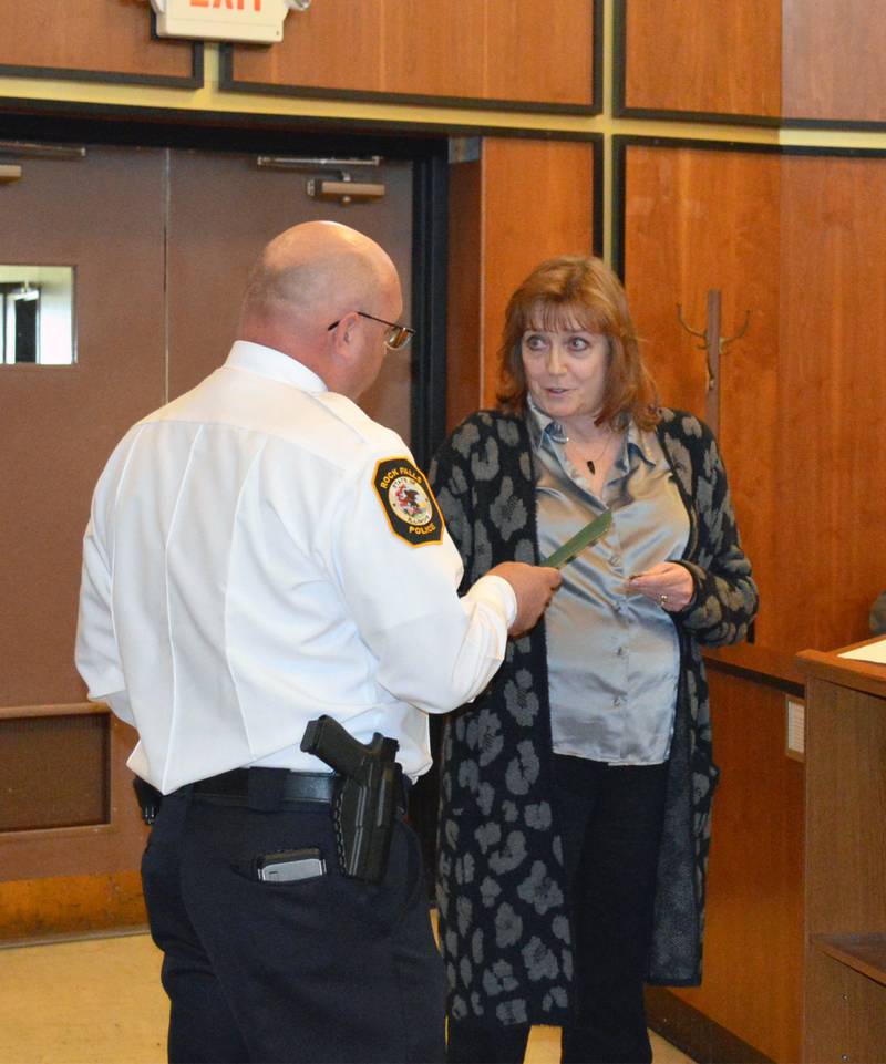 Rock Falls City Administrator Robbin Blackert, left, hands Police Chief David Pilgrim a Lifesaving Award for his work during a Feb. 14, 2024, emergency where he helped save the life of a Rockford man. The award was presented at the March 19, 2024, Rock Falls City Council meeting.