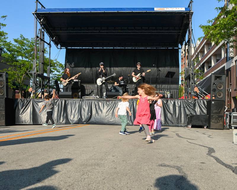 Kids enjoy dancing in the street as The Reception Band performs on Saturday May 31, 2025, during the Elmhurst Summer Kick Off Party held at City Centre Fountain Plaza in Elmhurst.