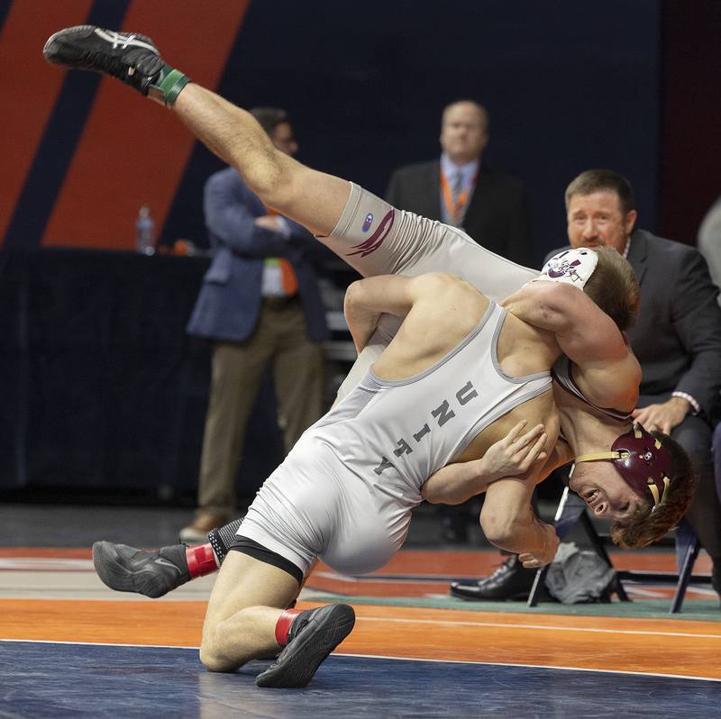 Richmond-Burton’s Emmett Nelson is thrown by Unity Christian’s Kaden Inman in the 144 pound weight class of the 1A state individual wrestling finals Saturday, Feb. 22, 2025, at State Farm Center in Champaign.