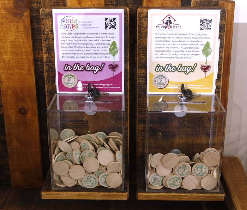 A wooden coin voting area for people to use to support local charities at the Food Shed, McHenry County's first co-op grocery store, on Friday, May 10, 2024, The he store opens on May 15.