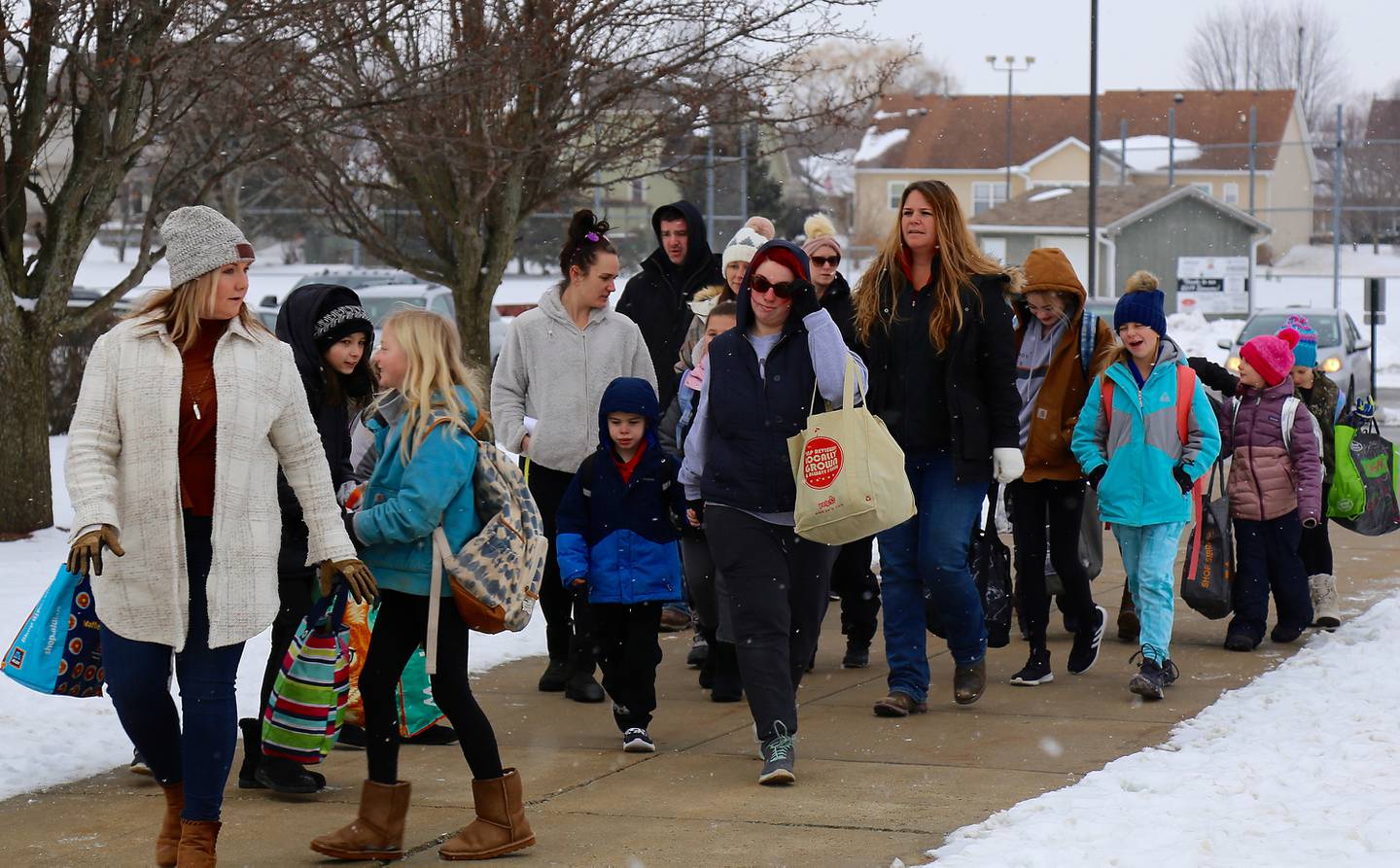 A group of parents who don’t want their children wearing masks walk to Kaneland John Stewart Elementary School in Elburn on Monday, Feb. 7, 2022.