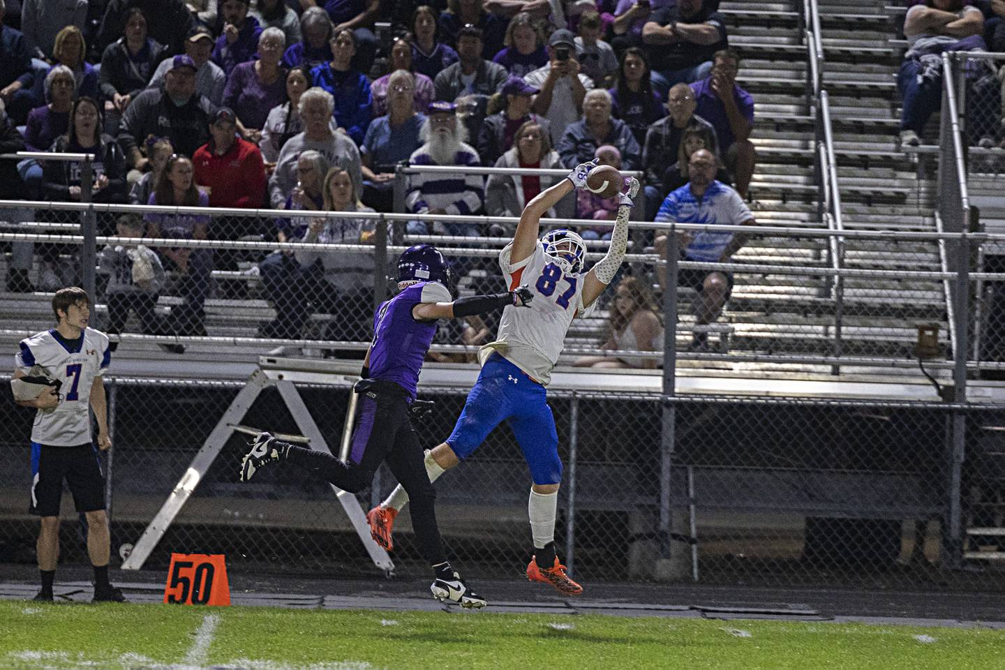 Genoa-Kingston’s Hayden Hodgson hauls in a catch for big yards against Dixon’s Cort Jacobson Thursday, Sept. 14, 2023 in a game at Dixon High School.