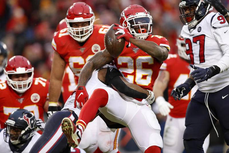 Chiefs running back Damien Williams scores a touchdown as he is hit by Houston Texans safety Justin Reid in the second half Sunday in Kansas City, Mo.