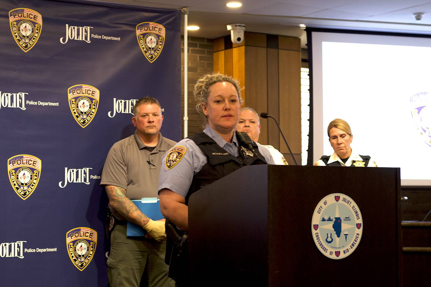 Joliet Police Officer Katelyn Kozielski speaking at a news conference about an investigation that uncovered unlawful drug activity and animal cruelty. The news conference was held Thursday, April 30, 2026 at Joliet City Hall.
