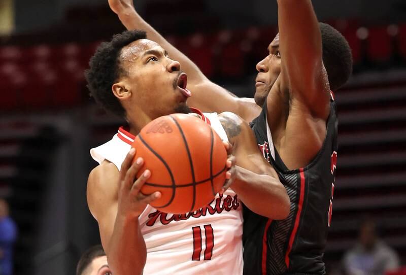 Northern Illinois' David Coit tries to score over Illinois Tech's Garrison Carter during their game Monday, Nov. 13, 2023, at the NIU Convocation Center in DeKalb.