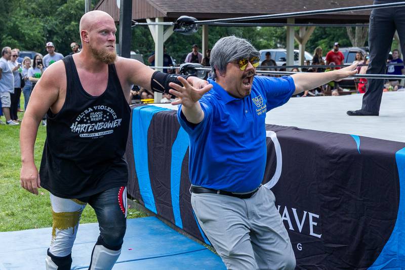 (left to right) Hartenbower grabs WWF Hall of Famer Sidney Bakabella outside of ring at the Taste of the Illinois Valley DreamWave Wrestling event on Saturday, August 2, 2025 at Centennial Park in Peru.