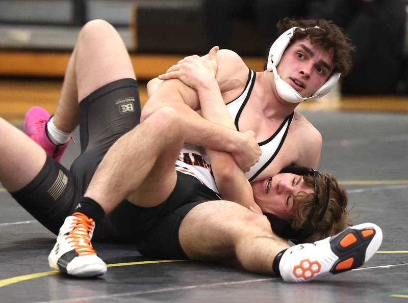 Kaneland’s Caden Vanik controls Sycamore’s Doug Gemberling at 165 pounds Thursday, Jan. 9, 2025, at Sycamore High School.