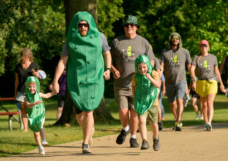 Charlie Benson of St. Charles participates in the Dill Dash fun run with his own little “gherkins”, daughter Genevieve, 3 and Marty, 5 during Inaugural Pickle Paradise event at Pottawatomie Park in St. Charles on Friday, June 21, 2024.