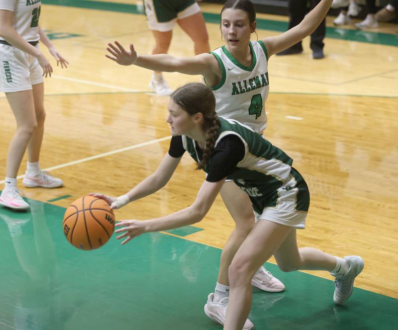 St. Bede's Parker McClain passes the ball in the lane around Alleman's Jillian Hoffman during the Class 2A Regional finals on Thursday, Feb. 19, 2026 at St. Bede Academy.