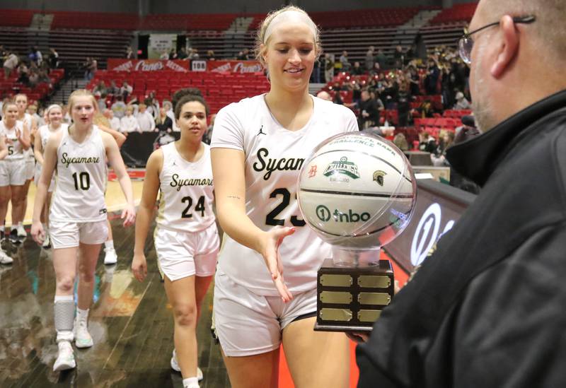 Sycamore's Evyn Carrier accepts the trophy after beating DeKalb in the girls game at the First National Challenge Friday, Jan. 27, 2023, at The Convocation Center on the campus of Northern Illinois University in DeKalb.