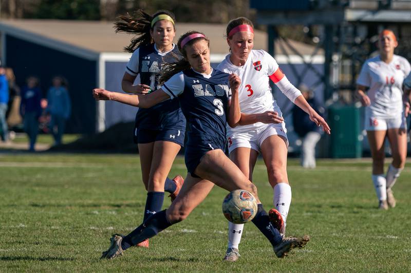 Oswego East's Anya Gulbrandsen (right) challenges Oswego’s Gillian Young for the ball during a soccer match at Oswego East High School on Thursday, Apr 6, 2023.