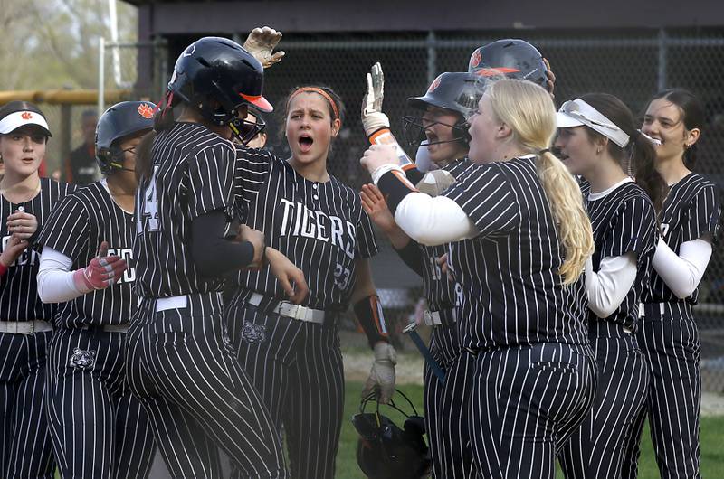 Crystal Lake Central's Lily Perocho is greeted by her teammates after hitting a two-run home run during a Fox Valley Conference softball game against Prairie Ridge on Monday, April 20, 2026, at Prairie Ridge High School.