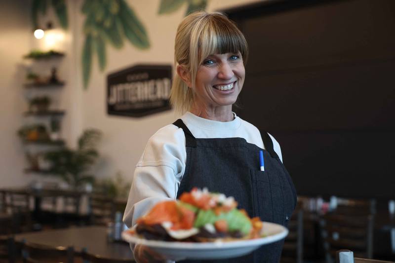 Jennifer Westcott holds an order of Huevo Rancheros at Jitterhead on Wednesday, Dec. 11, 2024 in Crest Hill.