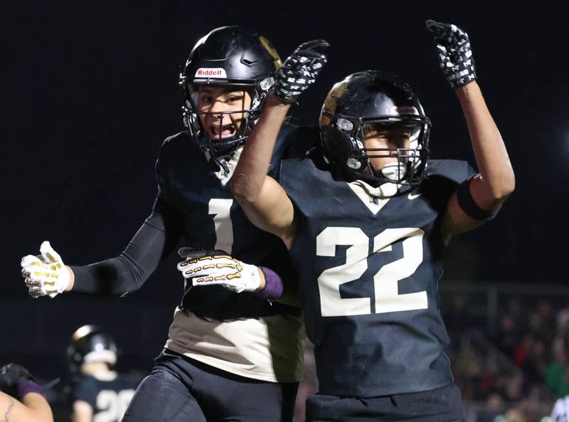 Sycamore's Dylan Curtis (right) celebrates after scoring a touchdown with teammate Josiah Mitchell during their game against La Salle-Peru Friday, Oct. 10, 2025, at Sycamore High School.