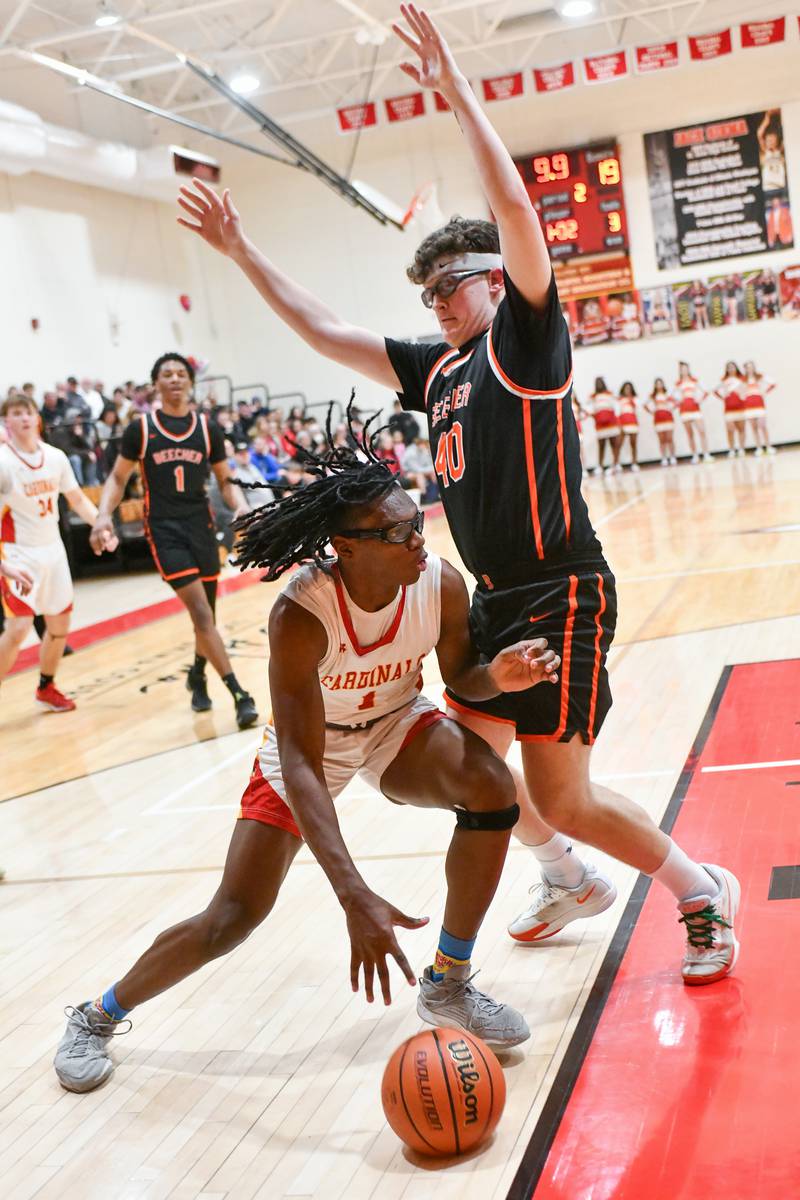St. Anne's Chris Link drives to the hoop against Beecher's Collin Malecha on Friday, Feb. 14, 2025, during the Cardinals' 70-38 victory over Beecher in the River Valley Conference championship.